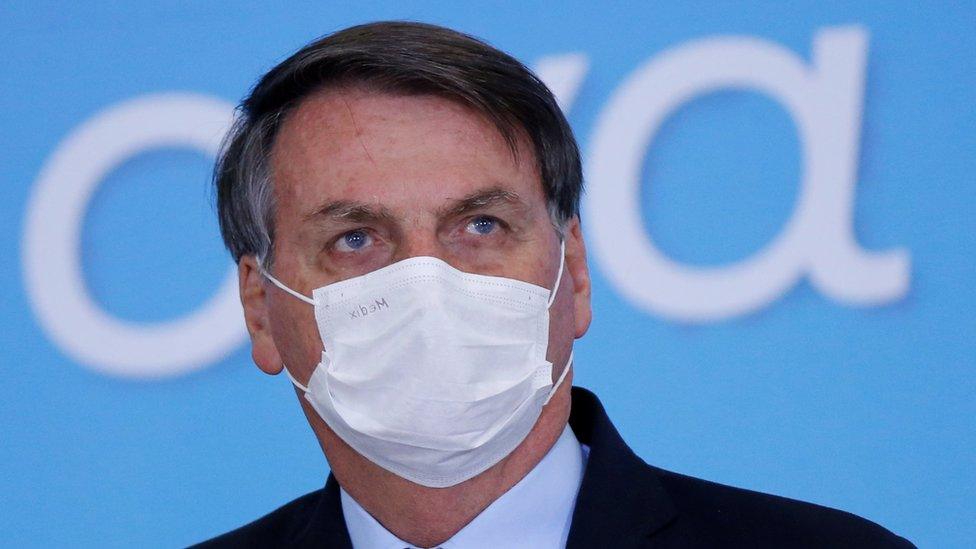 Brazil"s President Jair Bolsonaro wearing a protective mask looks on during the launching ceremony of the Plano Safra 2020/2021, an action plan for the agricultural sector, in Brasilia, Brazil, June 17, 2020