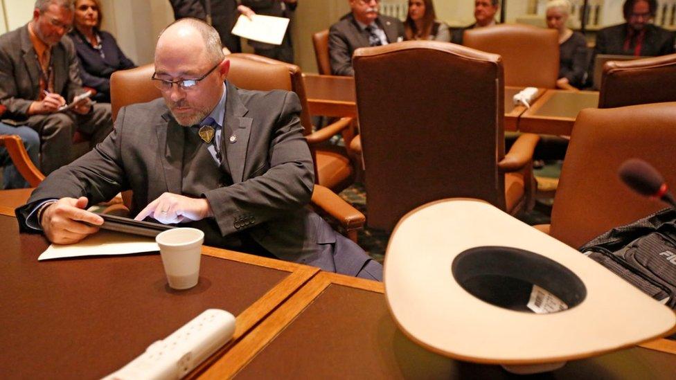 Representative Justin Humphrey sits next to his cowboy hat