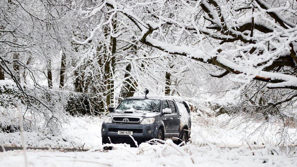 A car navigates in snow near Bradfield Dale, South Yorkshire