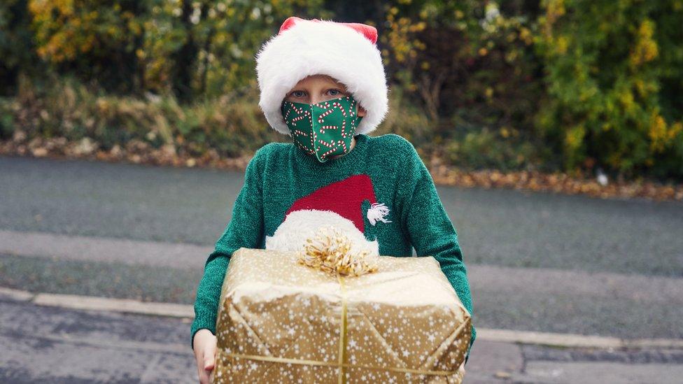 Boy-with-face-mask-and-present.