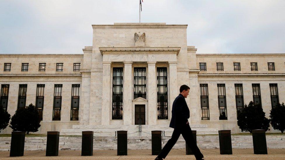 Man walks past US Federal Reserve