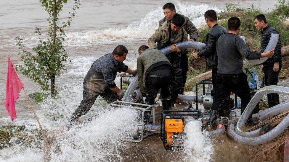 Rescue teams pump water at flooded Jiexiu Fenhe wetland park in Jinzhong, Shanxi Province of China.