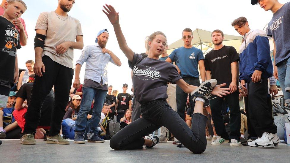 A woman breakdances at a festival in Moscow's Gorky Park