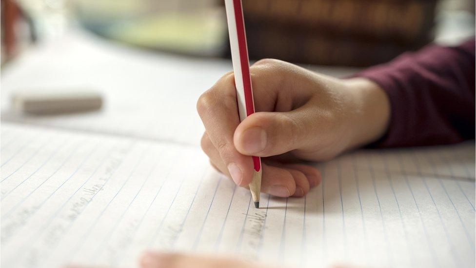 pupil writing on jotter