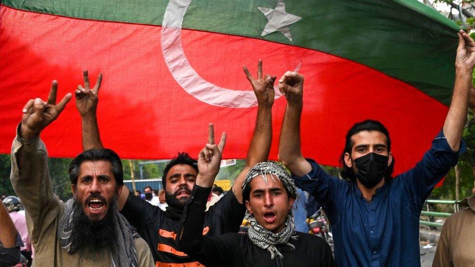 Pakistan Tehreek-e-Insaf (PTI) party activists and supporters of Pakistan's former Prime Minister Imran Khan celebrate after Supreme Court declared Khan's arrest "invalid", in Lahore on May 11, 2023.