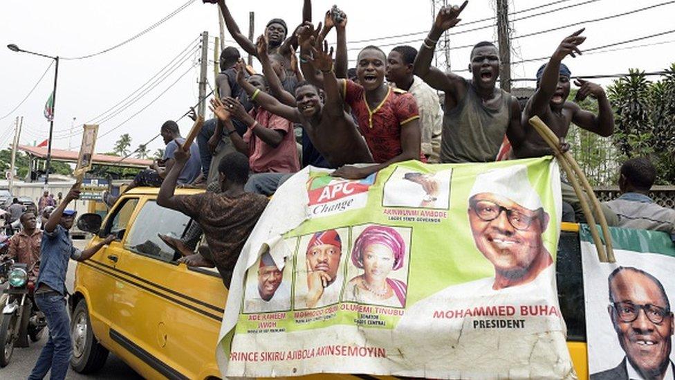 Supporters of newly-elected Nigerian President Muhammadu Buhari sit on top of a bus as they celebrate the victory their candidate in Lagos on April 1, 2015