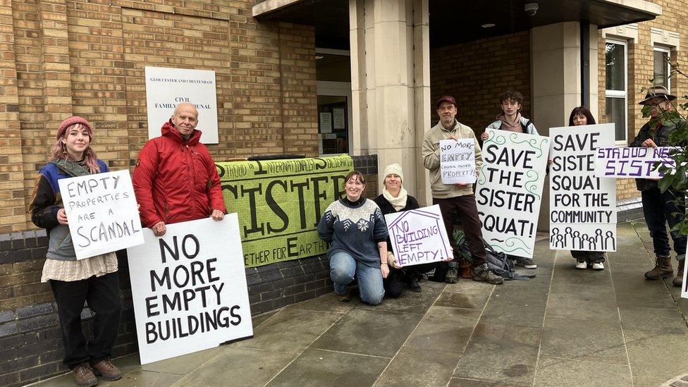 campaigners outside Gloucestershire County Court with placards.