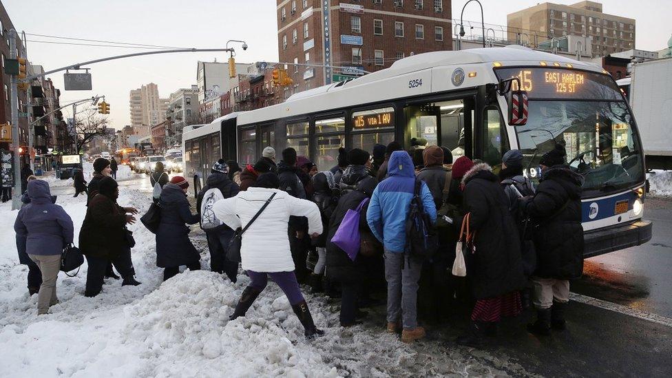 Commuters cram onto a New York City bus