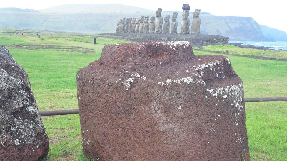 Pukao and standing Moai in distance