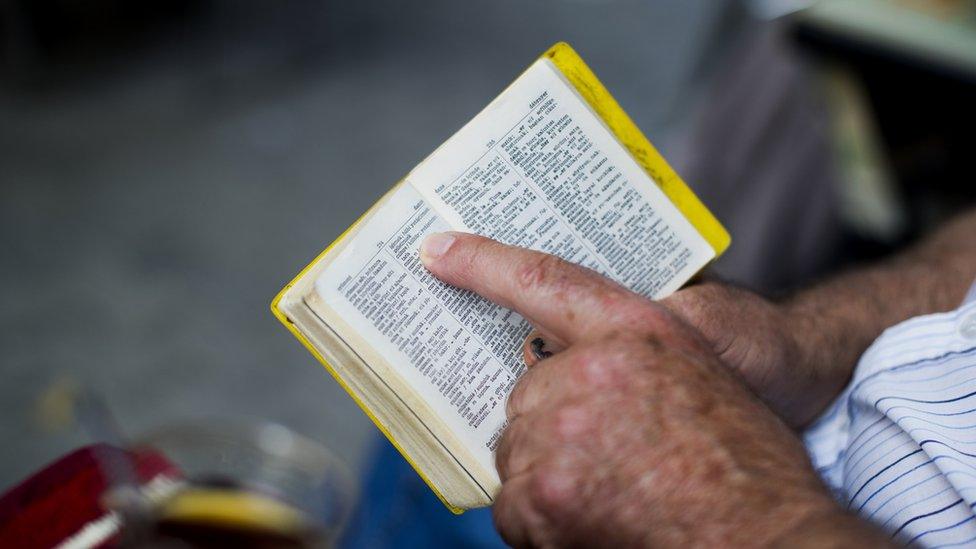 Man holding a French-Turkish dictionary