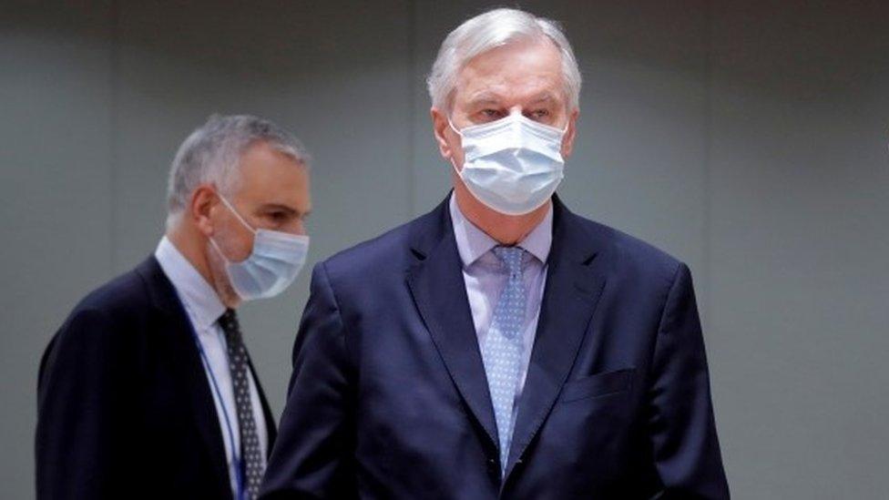 European Union"s chief Brexit negotiator Michel Barnier holds the pages of Brexit trade deal as he attends a meeting of the Committee of the Permanent Representatives of the Governments of the Member States to the European Union (COREPER) in Brussels,