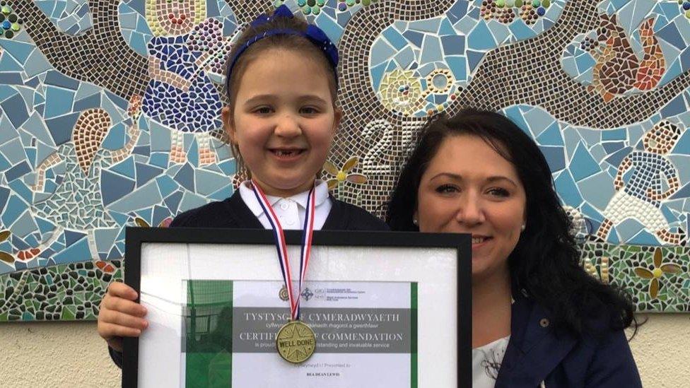 Bea and her mother with an award