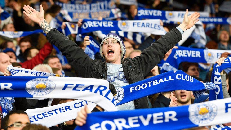 Leicester City fans cheer for their team