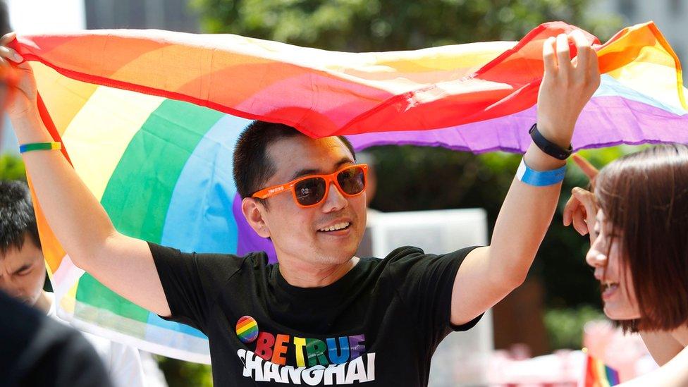 A man holds a rainbow flag at a pride festival in Shanghai in 2007