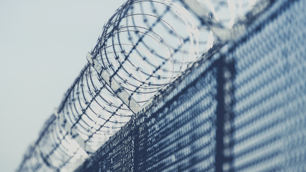 Barbed wire on a prison wall