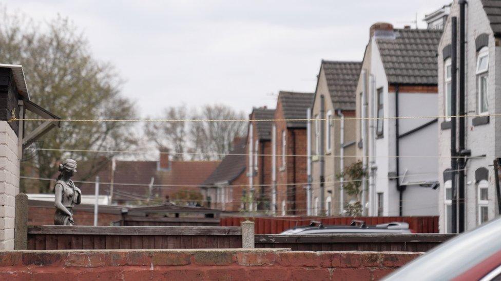 General view of back gardens in Clay Cross showing terraced houses and washing lines