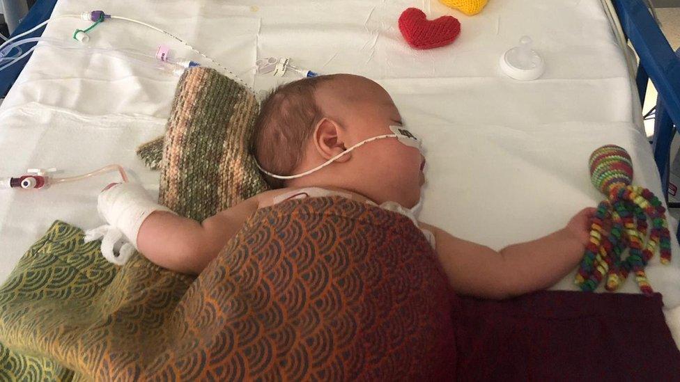 Baby sleeping in a hospital crib