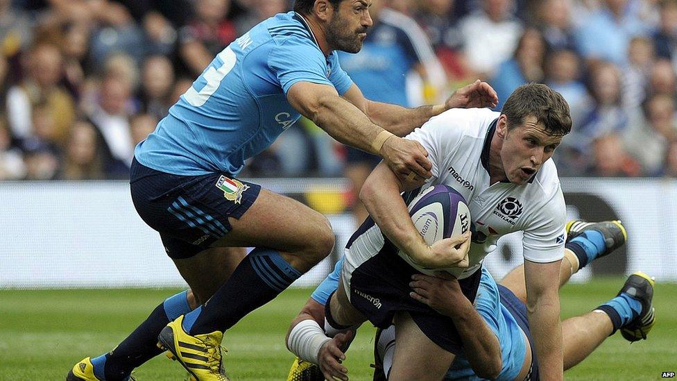 Scotland's centre Mark Bennett is tackled