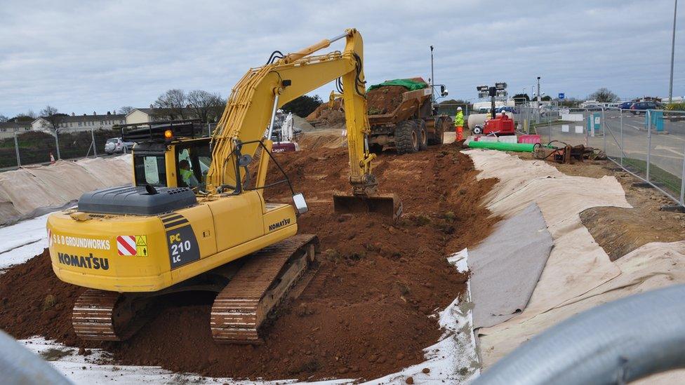PFOS-contaminated soil being buried in a bund at the entrance of Guernsey Airport