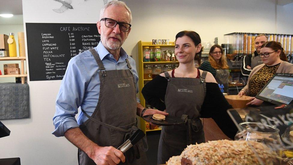 Jeremy Corbyn behind the counter of a coffee shop