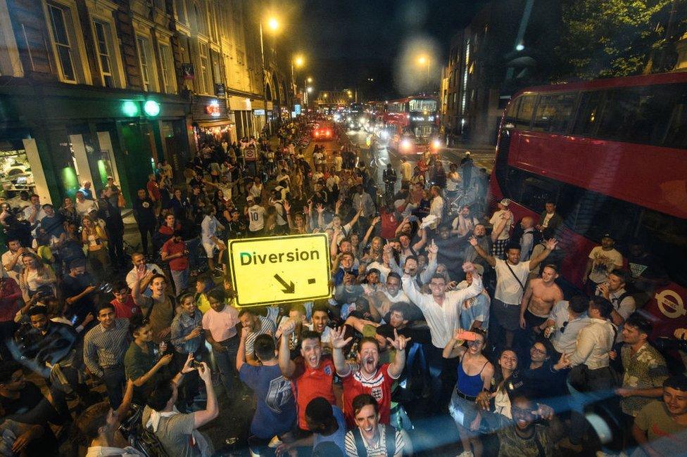 Football fans celebrate in a London street