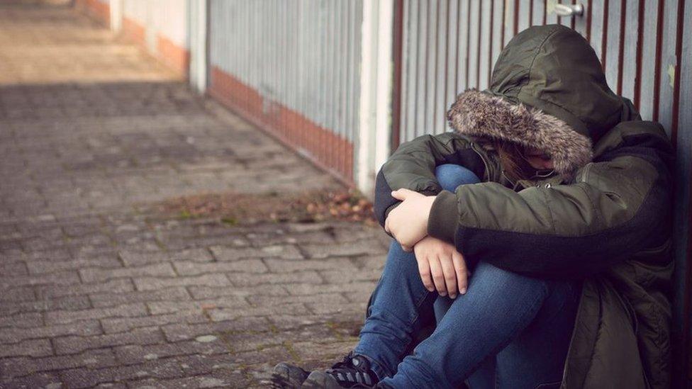 A stock picture of a boy sitting on the floor