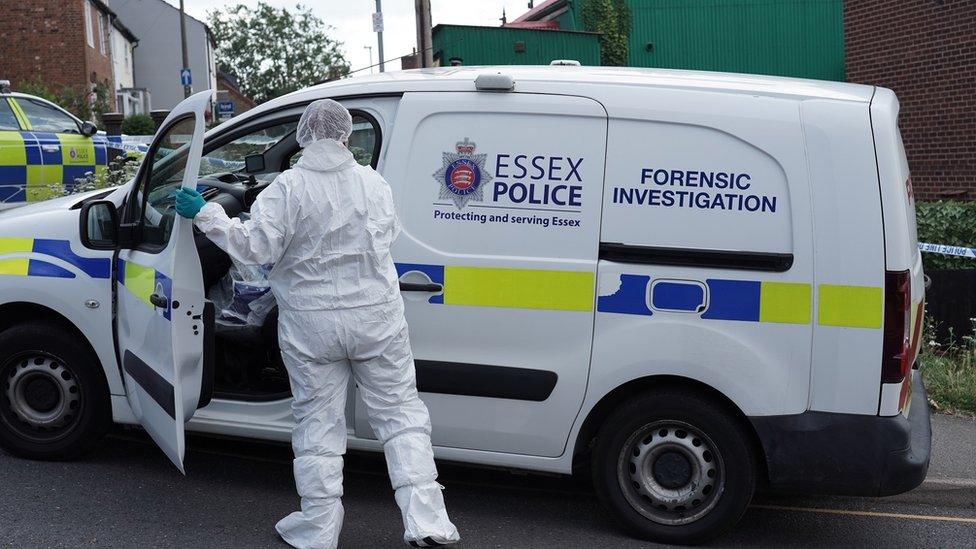 Forensic investigation van and officer in white protective clothing