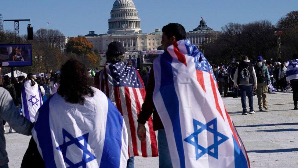 People wearing Israeli flags walk towards the Capitol