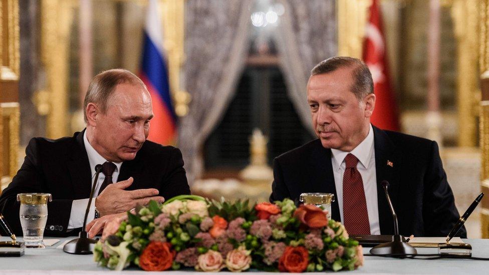 This file photo taken on October 10, 2016 shows Russian President Vladimir Putin (L) speaking to Turkish President Recep Tayyip Erdogan (R) as they attend a press conference in Istanbul.