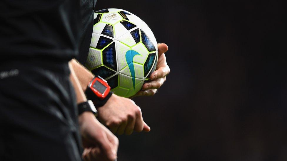 Referee with football