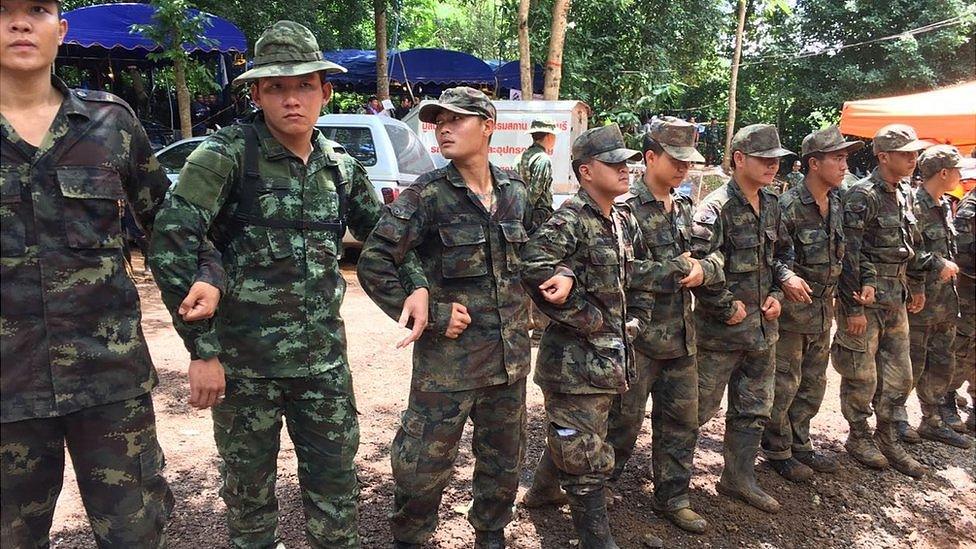 Soldiers form a cordon at the cave