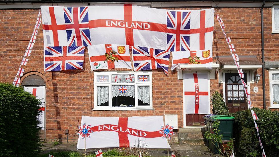 House adorned with flags