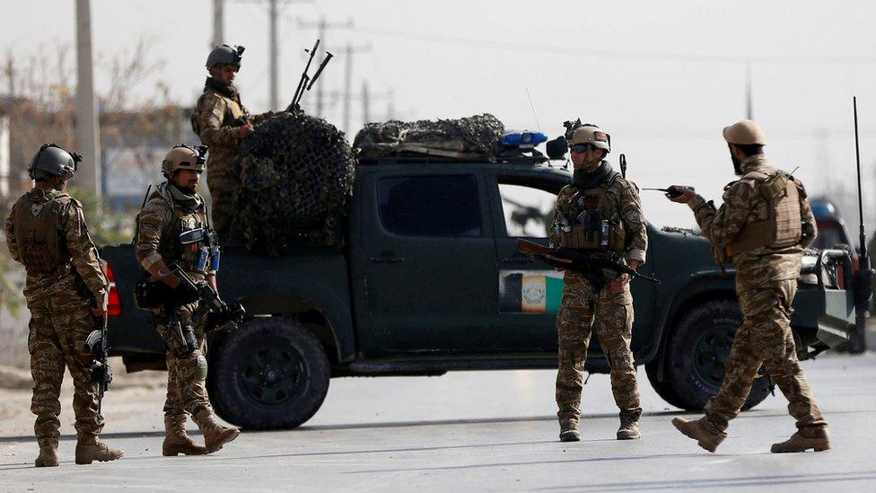 Afghan security forces keep watch at the site of a suicide attack in Kabul, 17 December 2018