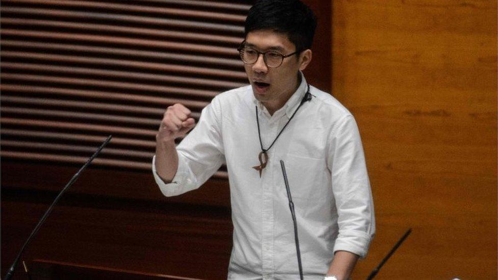 Newly elected lawmaker Nathan Law, 23, gestures after taking the Legislative Council Oath at the first meeting of the Sixth Legislative Council (Legco) in Hong Kong on October 12, 2016