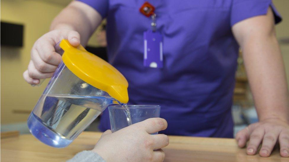 A picture of a water jug with a yellow lid