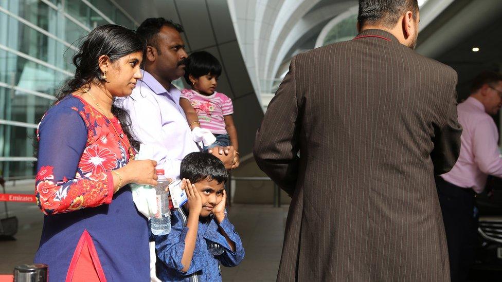 A family that were passengers on an Emirates jetliner that crash landed are helped to a taxi in Dubai, United Arab Emirates (3 August 2016)