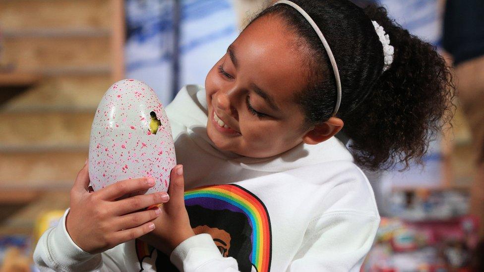 Girl with toy hatchimals egg