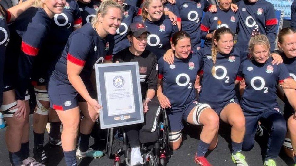 Lexi Chambers being given a world record certificate at Sandy Park in Exeter, by the England Women's rugby team