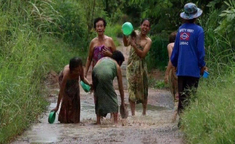 Grannies taking a bath in potholes