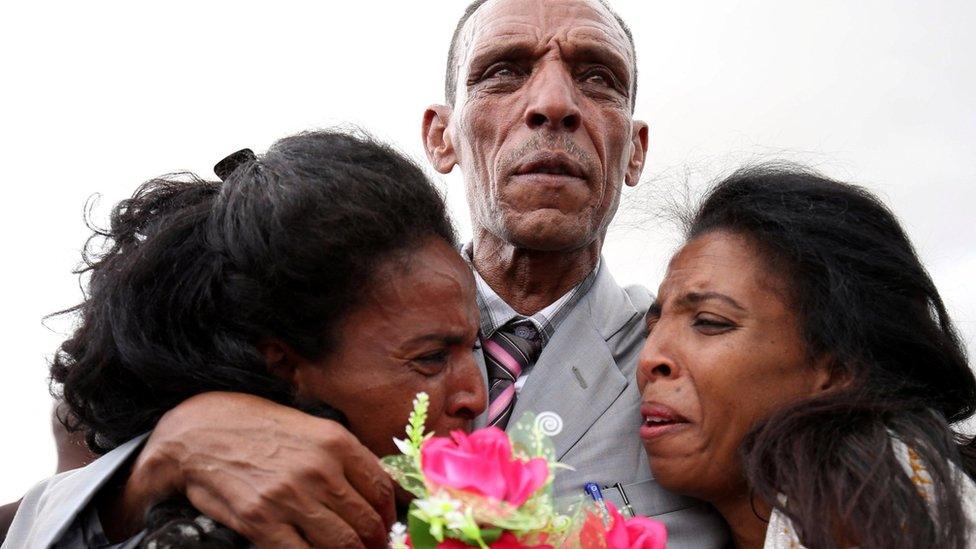 Adisalem Abu, reacts as he embraces his twin daughters, after meeting them for the first time in eighteen years, at Asmara International Airport after arriving aboard an Ethiopian Airlines flight in Asmara, Eritrea July 18, 2018.