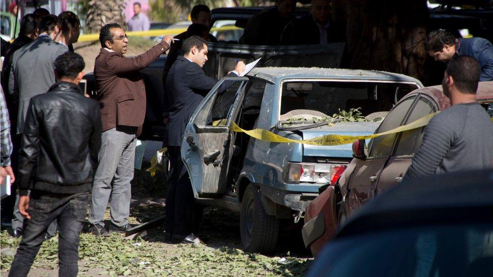 Egyptian explosives experts look for evidence at the site of a bomb explosion in Cairo, Egypt, Friday, 9 December 2016.