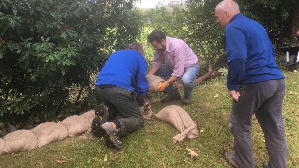 Owner Peter Welford and volunteers fill sandbags