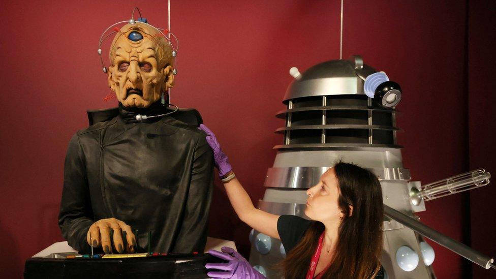 Head of museum exhibitions Catherine Johnson adjusts the head of a replica of the character Davros at the Doctor Who exhibition