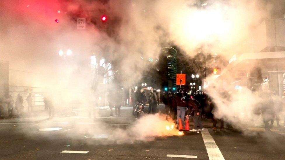 A fire burns on the street in Portland, Oregon