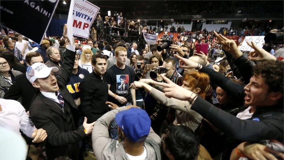 Supporters of Republican presidential candidate Donald Trump, left, face off with protesters after a rally on the campus of the University of Illinois-Chicago was cancelled due to security concerns Friday, March 11, 2016