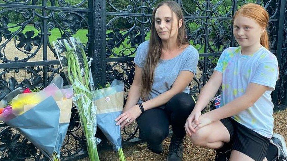 Kelly Key and her daughter Jessica, 10 laying flowers outside the gates of Sandringham