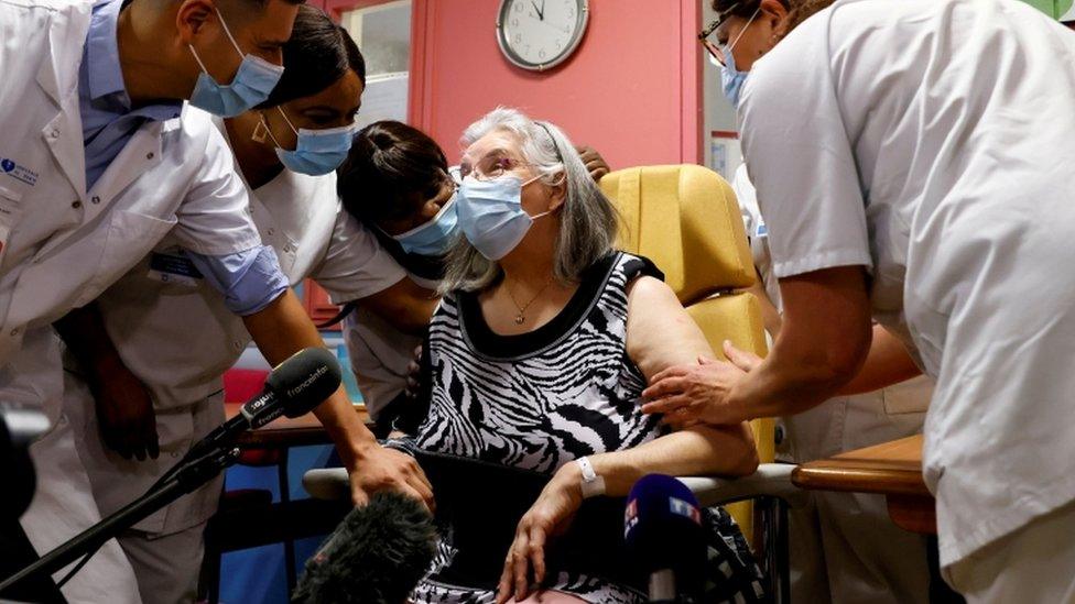 Woman getting first vaccine in France