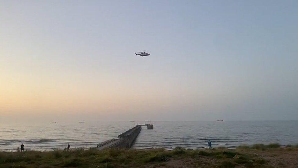 A search helicopter flies over the sea at Hartlepool