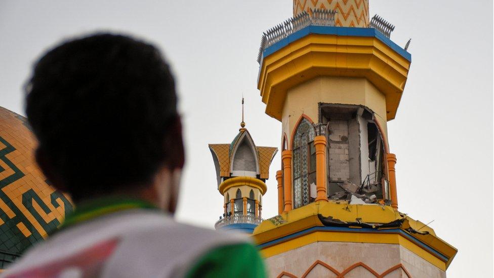 A man looks damage to a mosque following a strong earthquake in Mataram, Lombok