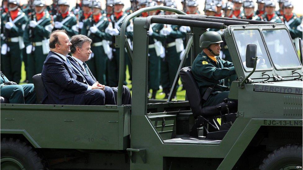 Colombia's President Juan Manuel Santos (right) sits in an army vehicle during a military ceremony in Bogota, Colombia, on 24 June 2015.